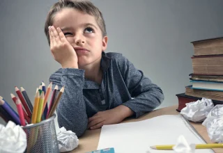 bored-and-fed-boy-up-doing-his-homework